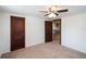 This bedroom features neutral carpet, two doors, and a ceiling fan at 4100 46Th N Ave, St Petersburg, FL 33714