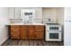 Compact kitchen featuring an oven range, sink, cabinets, and drawers at 4100 46Th N Ave, St Petersburg, FL 33714