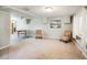 Spacious living room with neutral carpet, white walls, and a view of dining area, featuring an accent painting at 4100 46Th N Ave, St Petersburg, FL 33714