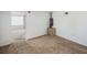 Spacious living room featuring neutral carpeting, white walls, a small cabinet and a view into another room at 4100 46Th N Ave, St Petersburg, FL 33714