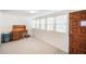 Bright office with neutral carpet, a desk, and a wooden door providing a comfortable workspace at 4100 46Th N Ave, St Petersburg, FL 33714