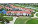 Aerial view of a complex with red roofs surrounded by lush green fairways at 6131 Bahia Del Mar Blvd # 139, St Petersburg, FL 33715