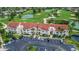 Aerial view of a complex with a red tile roof surrounded by a golf course and parking lot at 6131 Bahia Del Mar Blvd # 139, St Petersburg, FL 33715