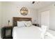 Bedroom featuring a queen sized bed with stylish wall decorations and wood accents at 6131 Bahia Del Mar Blvd # 139, St Petersburg, FL 33715