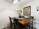 Dining room with seating for four, stylish light fixture, and decorative plates at each seat at 6131 Bahia Del Mar Blvd # 139, St Petersburg, FL 33715