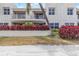 Attractive residential building featuring balconies, vibrant red shrubbery, and well-kept landscaping at 6131 Bahia Del Mar Blvd # 139, St Petersburg, FL 33715