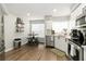 Bright kitchen featuring stainless steel appliances, white cabinets, and a small dining table at 6131 Bahia Del Mar Blvd # 139, St Petersburg, FL 33715