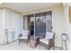 Cozy outdoor patio with two chairs, a table, and sliding glass doors, perfect for relaxing and enjoying the view at 6131 Bahia Del Mar Blvd # 139, St Petersburg, FL 33715
