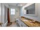 Bright bathroom featuring a granite countertop, white cabinets, and a shower-tub combo at 8202 Shadow Pine Way, Sarasota, FL 34238