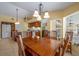 Cozy dining area with wooden table and view of the kitchen at 8202 Shadow Pine Way, Sarasota, FL 34238