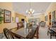 Elegant dining room features a glass-top table, chandelier, and natural light at 8202 Shadow Pine Way, Sarasota, FL 34238