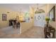 Bright foyer leading to a dining area, featuring tile floors and elegant decor at 8202 Shadow Pine Way, Sarasota, FL 34238
