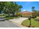 Inviting home featuring a tile roof, two-car garage, and a well-manicured lawn at 8202 Shadow Pine Way, Sarasota, FL 34238