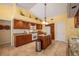 Well-lit kitchen with granite countertops, stainless steel appliances, and center island at 8202 Shadow Pine Way, Sarasota, FL 34238