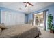 Stylish main bedroom with sliding glass doors to the pool, closet space and vaulted ceilings at 8202 Shadow Pine Way, Sarasota, FL 34238