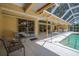 Covered patio with comfortable seating and access to the pool at 8202 Shadow Pine Way, Sarasota, FL 34238