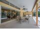 Covered patio with an outdoor dining set and a view of the screened pool at 8202 Shadow Pine Way, Sarasota, FL 34238