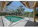 Capture a beautiful view of the screened pool with clear water and covered lounging area at 8202 Shadow Pine Way, Sarasota, FL 34238