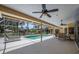 Screened in pool area with ceiling fans and comfortable lounge seating, perfect for relaxation at 8202 Shadow Pine Way, Sarasota, FL 34238