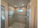 Stylish bathroom featuring a tiled walk-in shower with glass door and modern fixtures at 6179 Notre Dame Ter, North Port, FL 34291