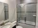 This bathroom has a shower and tub with sliding glass doors plus a vanity sink with granite countertop at 6179 Notre Dame Ter, North Port, FL 34291