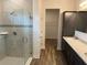 Modern bathroom with tiled glass shower, granite countertops, and dark cabinets at 6179 Notre Dame Ter, North Port, FL 34291