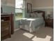 Cozy bedroom featuring a comfortable bed, natural light, and tasteful decor at 6179 Notre Dame Ter, North Port, FL 34291