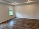Bright bedroom with modern vinyl floors and natural light streaming through the window at 6179 Notre Dame Ter, North Port, FL 34291