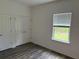 Well-lit bedroom with wood-look flooring, double closet and natural light at 6179 Notre Dame Ter, North Port, FL 34291
