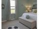 Bright bedroom featuring soft colors, a comfortable bed, stylish decor, and a large window overlooking the yard at 6179 Notre Dame Ter, North Port, FL 34291