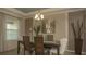 Elegant dining room featuring tray ceilings, stylish lighting, and a sophisticated dining set at 6179 Notre Dame Ter, North Port, FL 34291