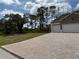 Charming home featuring a long brick driveway and a two-car garage at 6179 Notre Dame Ter, North Port, FL 34291