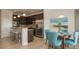 Open-concept kitchen and dining area with stainless steel appliances, breakfast bar, and adjacent dining table at 6179 Notre Dame Ter, North Port, FL 34291