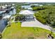 Stunning aerial view of a waterfront property with lush lawn, dock and boat lift on a canal at 24145 Blackbeard Blvd, Punta Gorda, FL 33955
