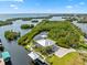 Breathtaking aerial view of waterfront home with a dock, boat lift, lush landscaping, and a serene coastal setting at 24145 Blackbeard Blvd, Punta Gorda, FL 33955
