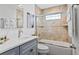 Well-lit bathroom with a shower over the tub, neutral tile, and a vanity with a white countertop at 24145 Blackbeard Blvd, Punta Gorda, FL 33955