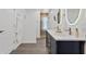 A long, well-lit bathroom with a double sink vanity and large mirrors at 24145 Blackbeard Blvd, Punta Gorda, FL 33955