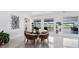 Elegant dining area featuring a modern table, stylish chairs, and large windows with outdoor views at 24145 Blackbeard Blvd, Punta Gorda, FL 33955