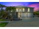 Charming two-story home with a well-maintained driveway, stairs to the front door, and tropical landscaping at 24145 Blackbeard Blvd, Punta Gorda, FL 33955