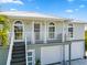 Charming two-story home with a metal roof, arched windows, elevated porch, and a convenient garage at 24145 Blackbeard Blvd, Punta Gorda, FL 33955