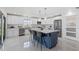 Bright kitchen with white cabinets, stainless steel appliances, and large island with marble countertop at 24145 Blackbeard Blvd, Punta Gorda, FL 33955