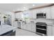 The kitchen has white cabinets, marble countertop, stainless steel appliances, and an island at 24145 Blackbeard Blvd, Punta Gorda, FL 33955