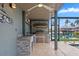 Luxurious outdoor kitchen with stainless steel grill, stone countertops, and ceiling fan, ideal for entertaining at 24145 Blackbeard Blvd, Punta Gorda, FL 33955
