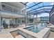 Luxurious outdoor pool area with a covered patio, comfortable seating, and well-maintained tile work at 24145 Blackbeard Blvd, Punta Gorda, FL 33955