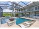 Enjoy this expansive pool area with a hot tub, a unique fire feature, and lounge chairs for relaxation at 24145 Blackbeard Blvd, Punta Gorda, FL 33955