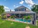 Aerial view of a screened-in pool and patio provides the perfect backyard oasis at 3008 Sutton Woods Dr, Plant City, FL 33566