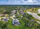 Aerial view showcases home near lake and golf course with a pool and lush greenery at 3008 Sutton Woods Dr, Plant City, FL 33566
