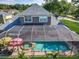Aerial view of a screened-in pool and patio provides the perfect backyard oasis at 3008 Sutton Woods Dr, Plant City, FL 33566