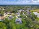 Aerial view of a home near a lake and golf course, featuring a pool and green landscape at 3008 Sutton Woods Dr, Plant City, FL 33566