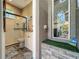 Elegant bathroom showcases a glass-enclosed shower, stylish fixtures, and direct access to the outdoor patio at 3008 Sutton Woods Dr, Plant City, FL 33566